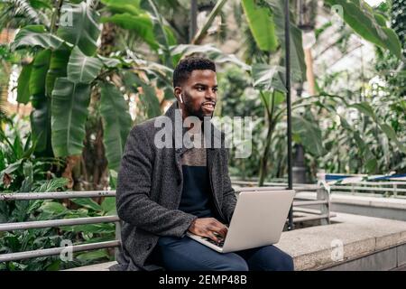 Afro businessman working On Laptop On The Street Stock Photo