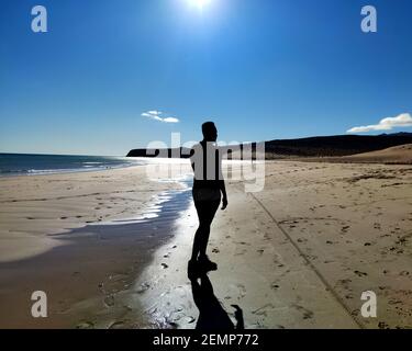 man silhouette on the sotavento beach. Fuerteventura Stock Photo