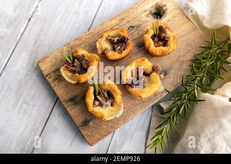 Brie bites with jam and nuts in crescent dough, mini appetizer dessert with cranberry or any jelly Stock Photo