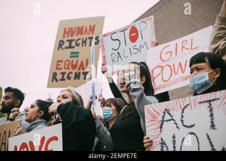 Male and female activists protesting for human rights in social movement Stock Photo