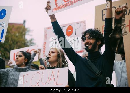 Smiling man with female activists protesting in social movement Stock Photo