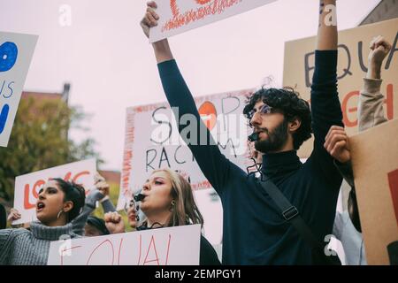 Male and female activist participating in anti-racism protest Stock Photo