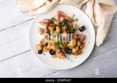 Roasted vegetables mix in a cast iron mini skillet ready to serve Stock Photo