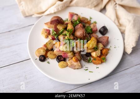 Roasted vegetables mix in a cast iron mini skillet ready to serve Stock Photo