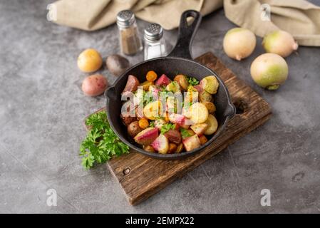 Roasted vegetables mix in a cast iron mini skillet ready to serve Stock Photo