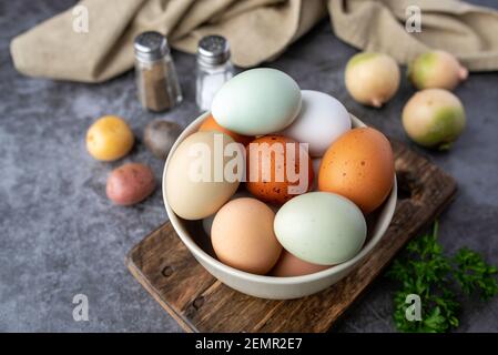 Fresh eggs from free range chickens on a small farm, beautiful colorful eggs from different breeds of chickens Stock Photo