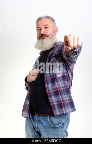 Studio portrait mature man dressed in casual clothes points to camera, I choose you concept, white backdrop Stock Photo