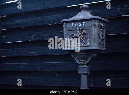 Vintage mailbox. Beautiful old-fashioned mailbox black. Mailbox on the background of a black fence Stock Photo
