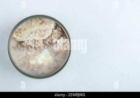 Canned beef. Open tin on white background Stock Photo