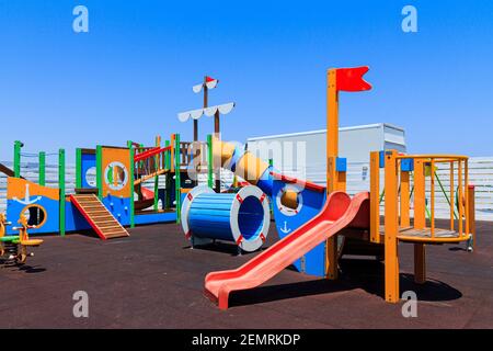 Children's wooden playground recreation area at public park Stock Photo