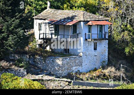 Old abandoned whitewashed stone house with a shingled ash-green slate rooftop in the outskirts of  Kastanitsa in Arcadia Peloponnese,  Greece. Stock Photo
