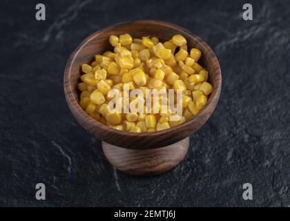 Marinated corn seeds in wooden bowl Stock Photo