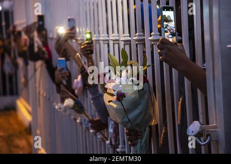 Fans with flowers near the funeral home where Nipsey Hussle's