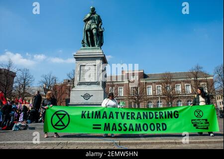 A group of activists from the Extinction Rebelion are seen holding a big banner, during the action that took place in The Hague, in April 15th, 2019. Extinction Rebellion (XR) is an international movement that uses non-violent civil disobedience to achieve radical change in order to minimize the risk of human extinction and ecological collapse. From Monday 15 April, Extinction Rebellion is taking action on the streets of cities all over the world. In The Hague, the 'International Rebellion XR Netherlands' declared its own full-scale rebellion to demand decisive action from governments on clima