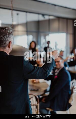 Businessman with wineglass during office party Stock Photo
