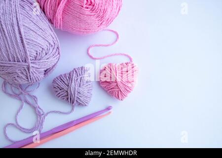 Threads,hooks, and two hearts lay on a white background.Holiday card, background. The concept of Valentine's Day, March 8, Mother's Day. Space for Stock Photo