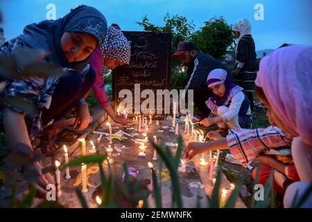  Kashmiri Shia Muslim girls are seen lighting candles on the grave of their relatives during the occasion of Shab-e-Barat in Srinagar. Every year, Shab-e-Barat is observed on the night between 14th and 15th of Sha'aban, which is the eighth month of the Islamic calendar. According to Islam, Shab-e-Barat means the night of forgiveness. It is considered to be the night when Allah forgives sinners. Shab-e-Barat is also known as Bara'a Night and Mid-Sha'ban. In The Arab world, it's referred to as Laylat al-Bara'at. The festival falls in the run up to Ramadan and is considered the night when Allah f