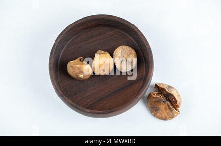 Dried tasty figs on wooden plate Stock Photo