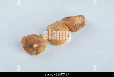 Three dried figs on white background Stock Photo