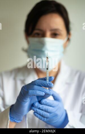 Nurse, female doctor holds syringe- Covid -19 va Stock Photo
