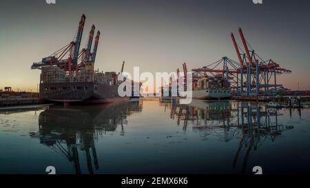 Container terminal in the port of Hamburg in the evening Stock Photo
