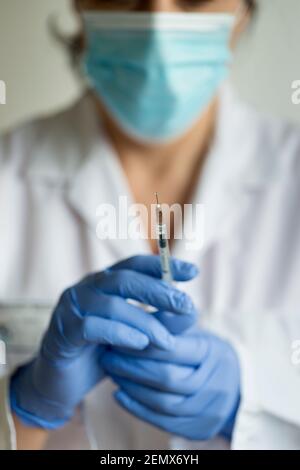 Selective focus-female Nurse, female doctor holds syringe- Covid -19 vaccine, Vaccination Program, UK Stock Photo