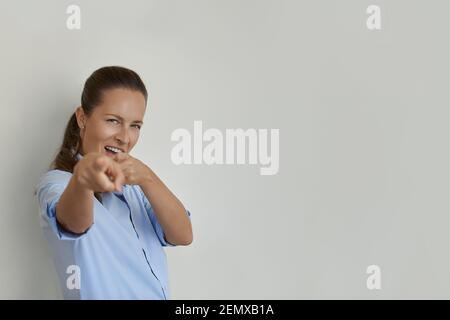 Woman winking and pointing with finger at camera Stock Photo