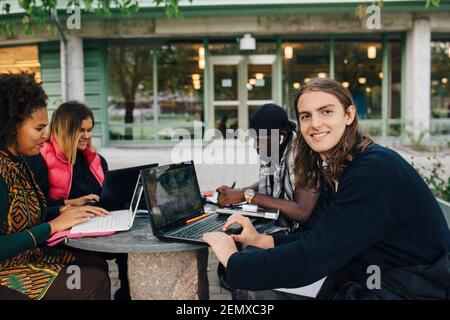 Smiling university student studying in college Stock Photo
