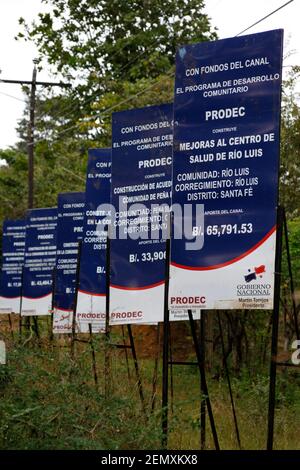 Sign promoting improvements to Rio Luis community health centre funded by payments from the Panama Canal, Santa Fe, Veraguas Province, Panama Stock Photo