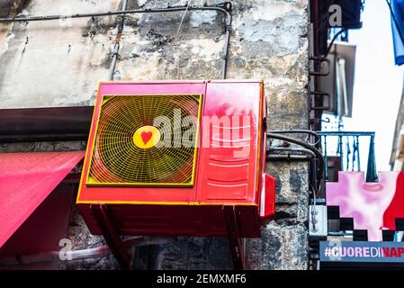 Naples, Italy - September 9, 2019: Red air conditioner with a drawn heart on a street in the old town of Naples, Italy Stock Photo