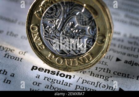 DICTIONARY DEFINITION OF WORD PENSION WITH ONE POUND COIN RE PENSIONS RETIREMENT SAVINGS PENSIONERS ETC UK Stock Photo