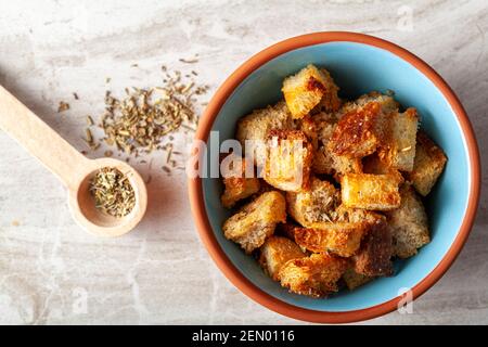 Close up flat lay image of home made croutons in a bowl. Bread cubes were baked to crisp in oven and dipped into olive oil or butter and finished with Stock Photo