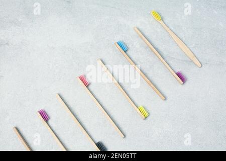 Many Bamboo toothbrushes on light stone table Zero waste concept for self-care . Plastic-free, organic Stock Photo