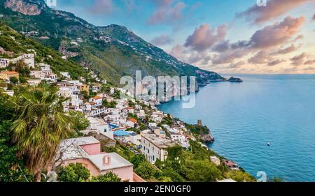The charming Italian seaside town of Praiano, perched above steep rocky cliffs with magnificent views of the Amalfi coast. Stock Photo