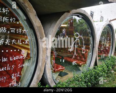 Private dining rooms made of cement pipes are inlayed into the wall of the  red wine museum, where the industrial style cafeteria located, in Liangjian  Stock Photo - Alamy