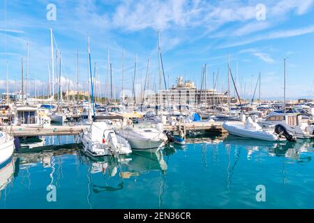 The busy harbor at Antibes, France, filled with boats, sailboats and luxury yachts on the French Riviera. Stock Photo