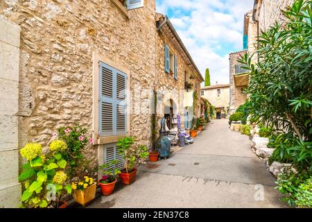 A typical quaint street of shops in the medieval hilltop village of Gourdon, France, in the Provence Alpes Maritimes area of Southern France. Stock Photo