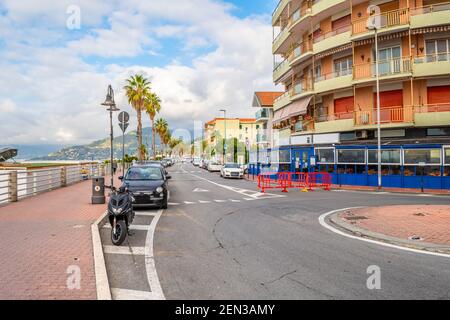 The main coastal road along the Mediterranean sea and beach through the town of Ventimiglia, Italy, in the Imperia region of the Italian Riviera Stock Photo