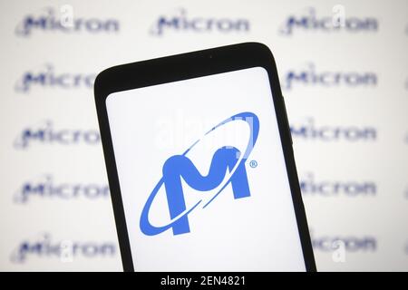 In this photo illustration a Micron logo is seen on a smartphone and a pc screen Stock Photo
