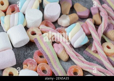 Colorful marshmallows and jellybeans on the marble background Stock Photo