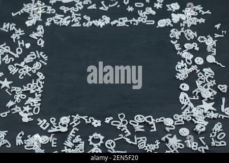 Letter symbols, icons and pins on black background Stock Photo