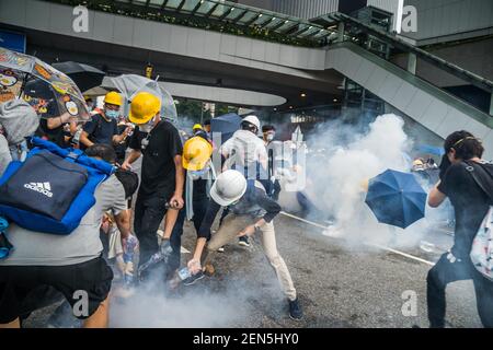  Protester trying to use water to put out the tear gas which the police used against them. Thousands of protesters occupied the roads near the Legislative Council Complex in Hong Kong to demand to government to withdraw extradition bill. The Hong Kong government has refused to withdraw or delay putting forward the bill after tens of thousands of people marched against it on Sunday. (Photo by Geovien So / SOPA Images/Sipa USA) 