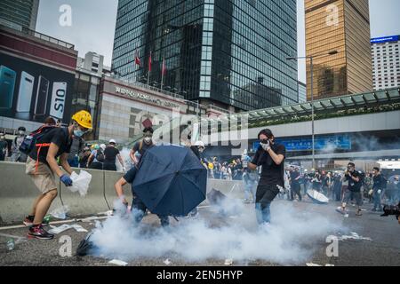  Protester trying to use water to put out the tear gas which the police used against them. Thousands of protesters occupied the roads near the Legislative Council Complex in Hong Kong to demand to government to withdraw extradition bill. The Hong Kong government has refused to withdraw or delay putting forward the bill after tens of thousands of people marched against it on Sunday. (Photo by Geovien So / SOPA Images/Sipa USA) 