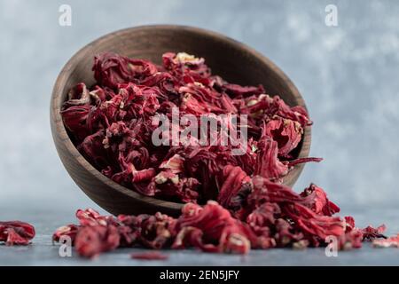 Dry hibiscus tea in wooden bowl Stock Photo