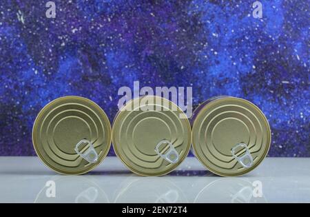 Close up photo of closed tin can on blue background Stock Photo