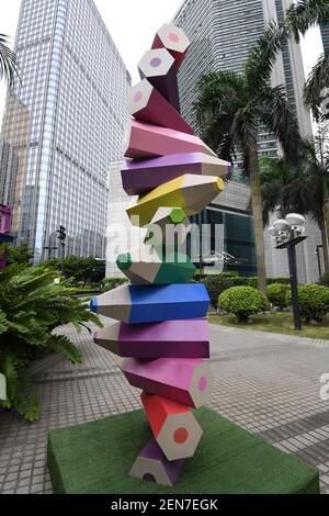 A Chinese man walks past a colored pencil installation on display at a  square amongst office buildings in Guangzhou city, south China's Guangdong  province, 23 June 2019. A square amongst a cluster
