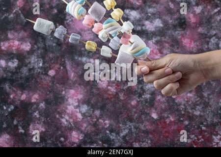Colorful marshmallows on the wooden sticks to be grilled Stock Photo