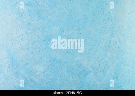 Background abstract texture of rough plaster with white splashes of blue. Stock Photo