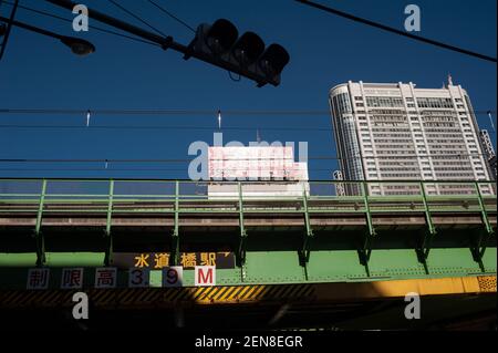 01.01.2018, Tokyo, Japan, Asia - Cityscape of the Japanese capital city with the Tokyo Dome Hotel under a clear blue sky and a railway bridge. Stock Photo