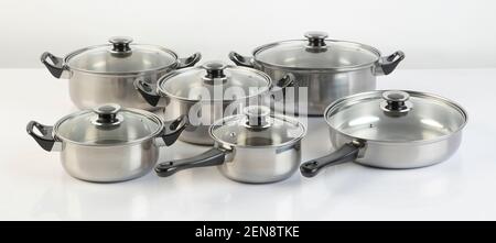 Set of stainless pots with lids isolated on white background Stock Photo